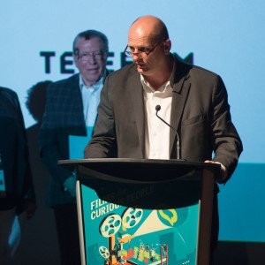 Ed Barreveld at a podium on-stage