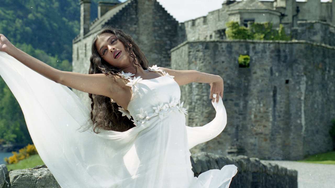 a woman dancing in a white dress