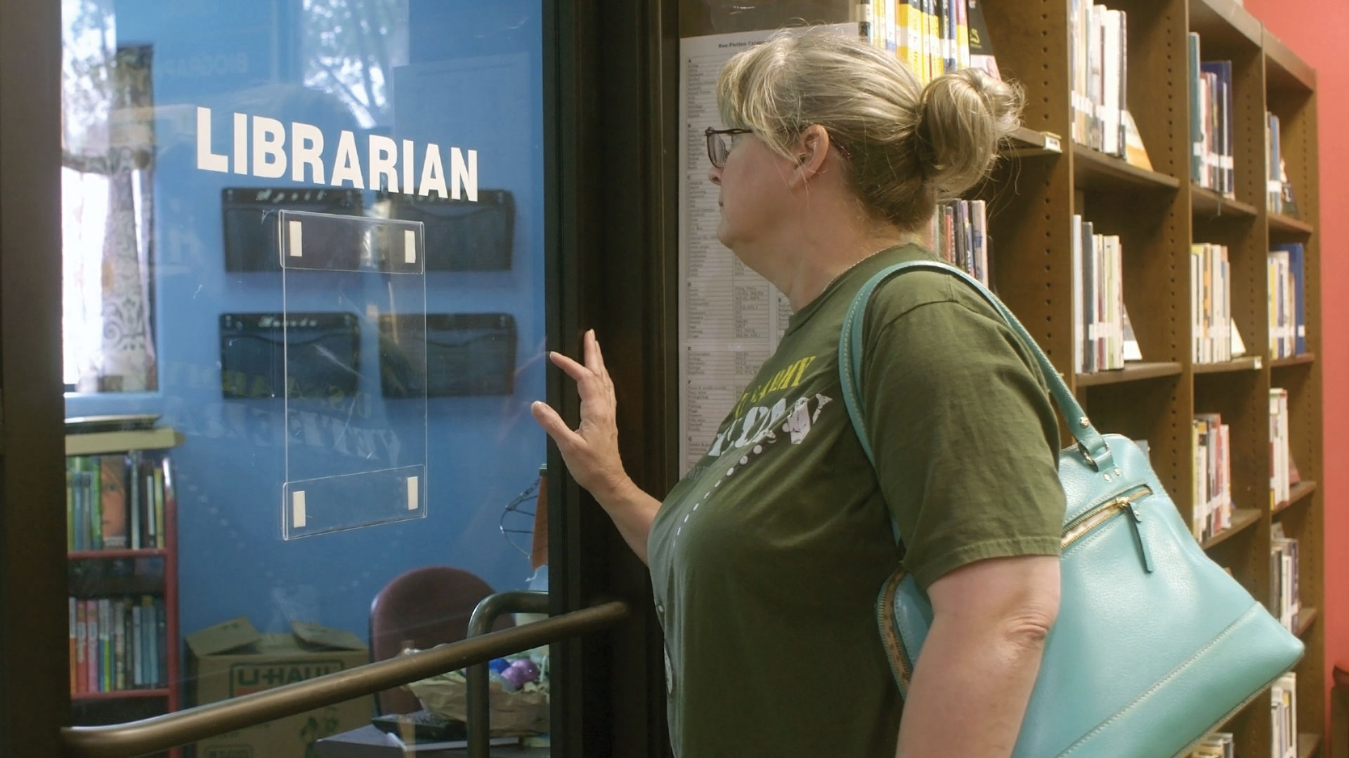 woman pushing open door that says Librarian