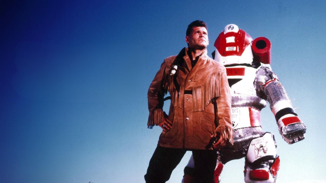 a man in a fringe suede jacket next to a padded suit