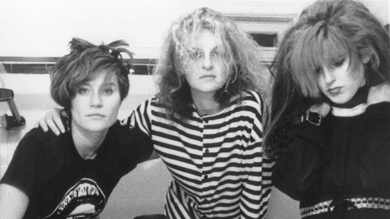 three women in the 80s posing for a photo together